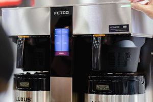 Fetco batch coffee brewer with dual stainless steel dispensers, ideal for commercial cafés and high-volume brewing.