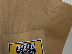 Encore Coffee & Chocolate kraft coffee bags with one-way degassing valves and custom logo label for fresh-roasted packaging.