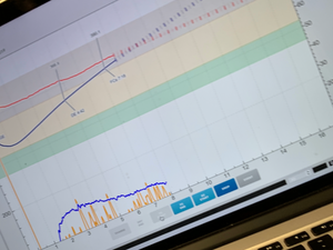 Close-up of a coffee roasting profile graph displayed on a laptop screen, showing temperature curves and rate of rise data.