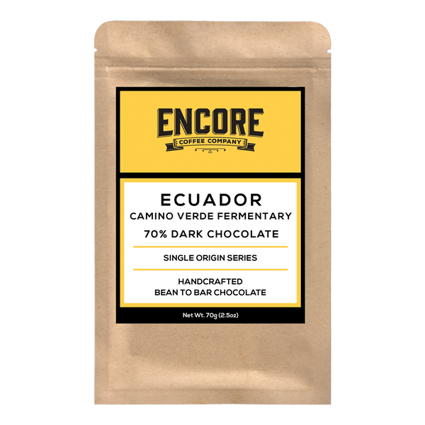 A rectangular dark chocolate bar is shown with the brand name "Encore" written in white letters on the top left corner of the packaging. The background of the packaging is a light brown color and features a white square in the center with the word "Ecuador" written in white letters. The chocolate bar is surrounded by images of cocoa pods and leaves, also in white.