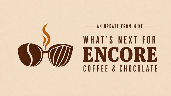 An Update from Mike: What’s Next for Encore Coffee & Chocolate, with coffee bean and cacao pod glasses and rising steam.