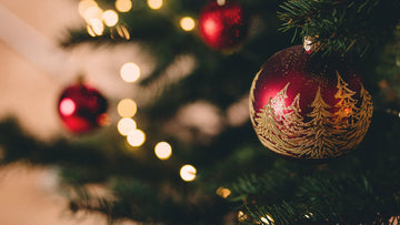 Image of Christmas tree with round red ornaments.