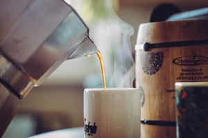 Moka Pot pouring coffee into coffee mug