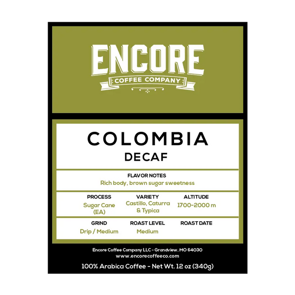 A green background with the Encore label featuring the words "Colombian Cauca" in bold font. Below the title is a description of the coffee, and at the bottom are the weight measurements.