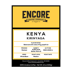 The image is a product label for Kenya Estate Peaberry coffee. The top of the label features a yellow banner with the Encore logo. The bottom half of the label contains information about the coffee, including its name, "Kenya Estate Peaberry," and additional text describing its flavor profile and origin. 