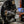 Commercial coffee roaster from US Roaster Corp in operation with green coffee beans inside, monitored by a connected laptop for roast profiling.